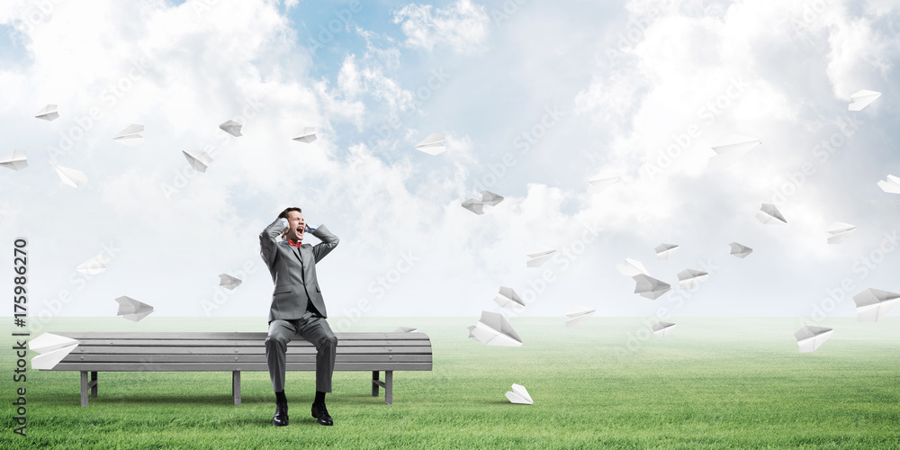 Young man in suit in park dont want to hear anything Young man in suit in park dont want to hear anything
