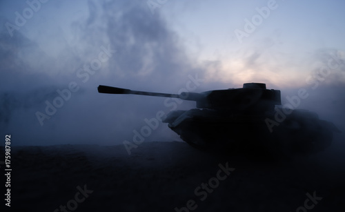 War Concept. Military silhouettes fighting scene on war fog sky background, World War Soldiers Silhouettes Below Cloudy Skyline at sunset. Armored vehicles. German tank in action