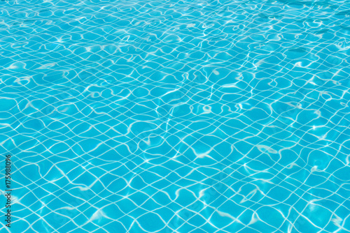 Beautiful ripple wave and blue water surface in swimming pool, Bright water and blue tile in pool for background and abstract