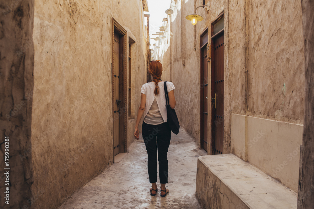 Woman standing in narrow passageway Woman standing in narrow passageway