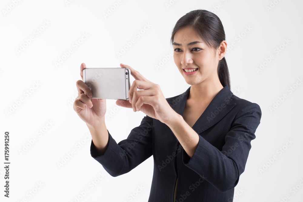 Asian Business Woman smiling, Woman stand and using Smartphone for take phictures, isolated on white background, Woman with technology concept. Asian Business Woman smiling, Woman stand and using Smartphone for take phictures, isolated on white background, Woman with technology concept.