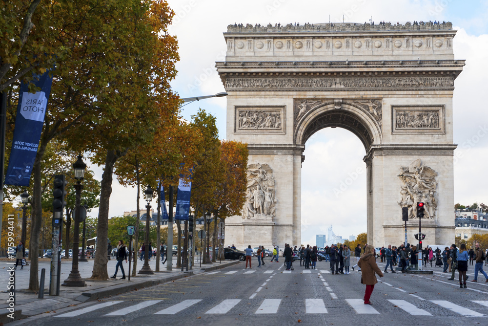A view of Arc de Triomphe with autumn colors, from Champs-Elysees avenue in November 2016 in Paris, France.