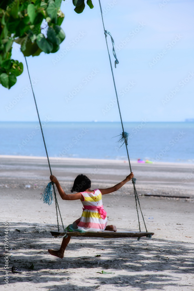 child sitting on a swing