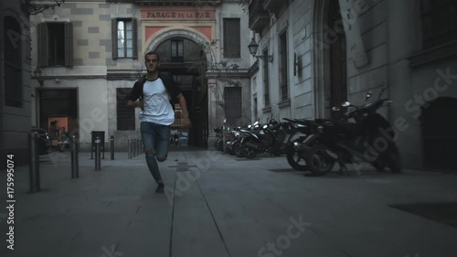 Wallpaper Mural Action shot of handsome young millennial hipster man in trendy outfit running late to meeting or plane or train, looking at smartphone, nervous and stressed speeding up not to miss chance to win Torontodigital.ca