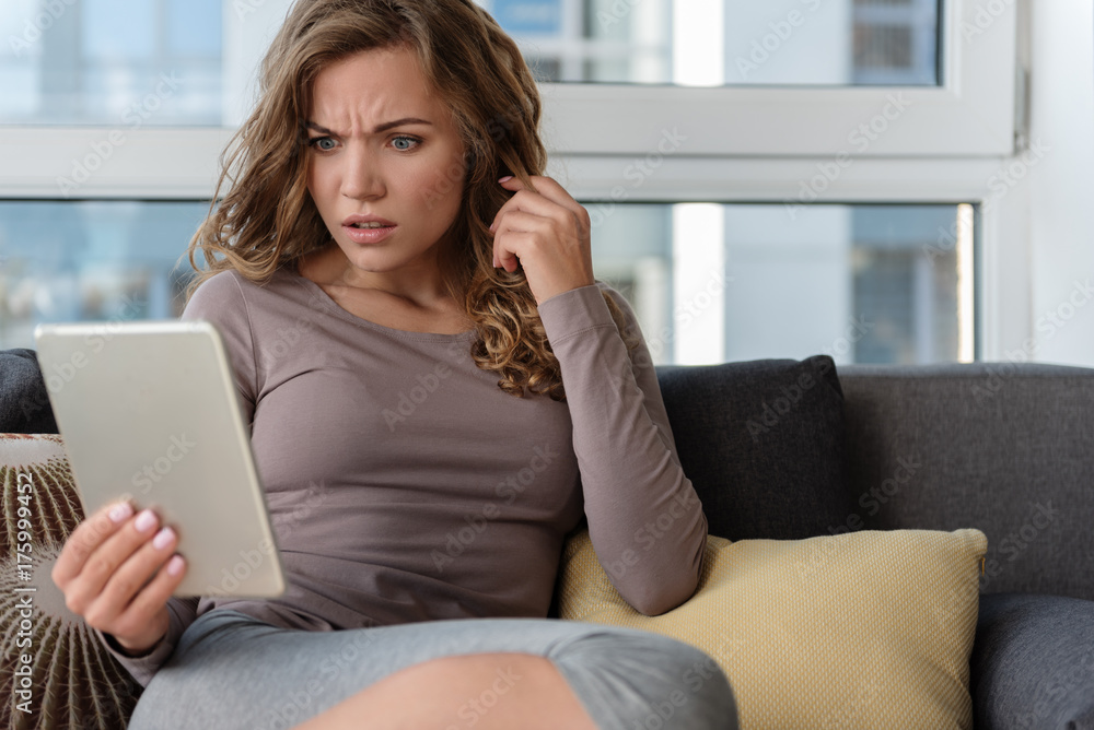 Astonished woman watching at digital device Astonished woman watching at digital device