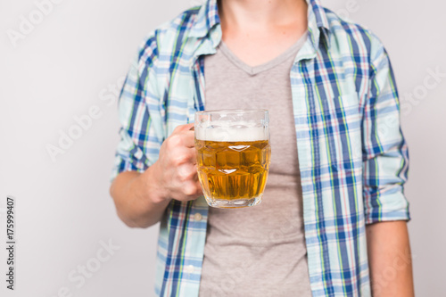 Close up of man holding a mug of beer.