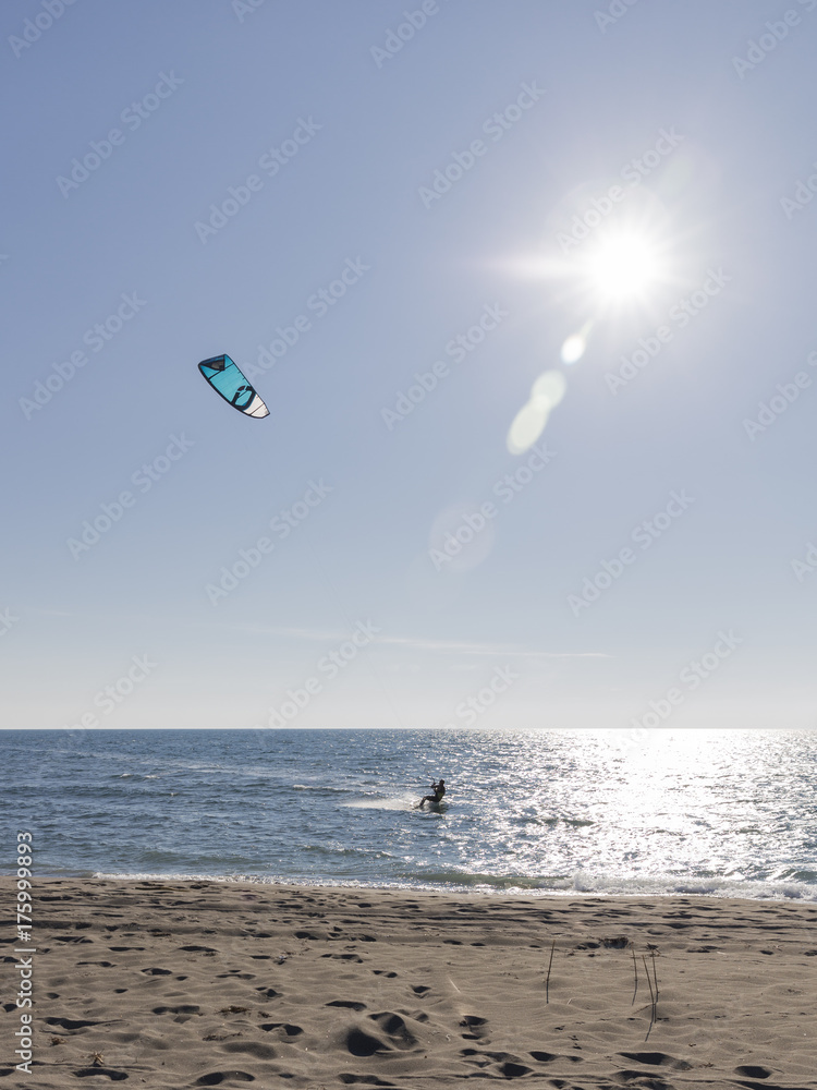 bold kitesurfer riding the waves