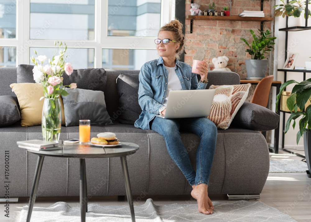 Dreamy smiling young woman working at home Dreamy smiling young woman working at home