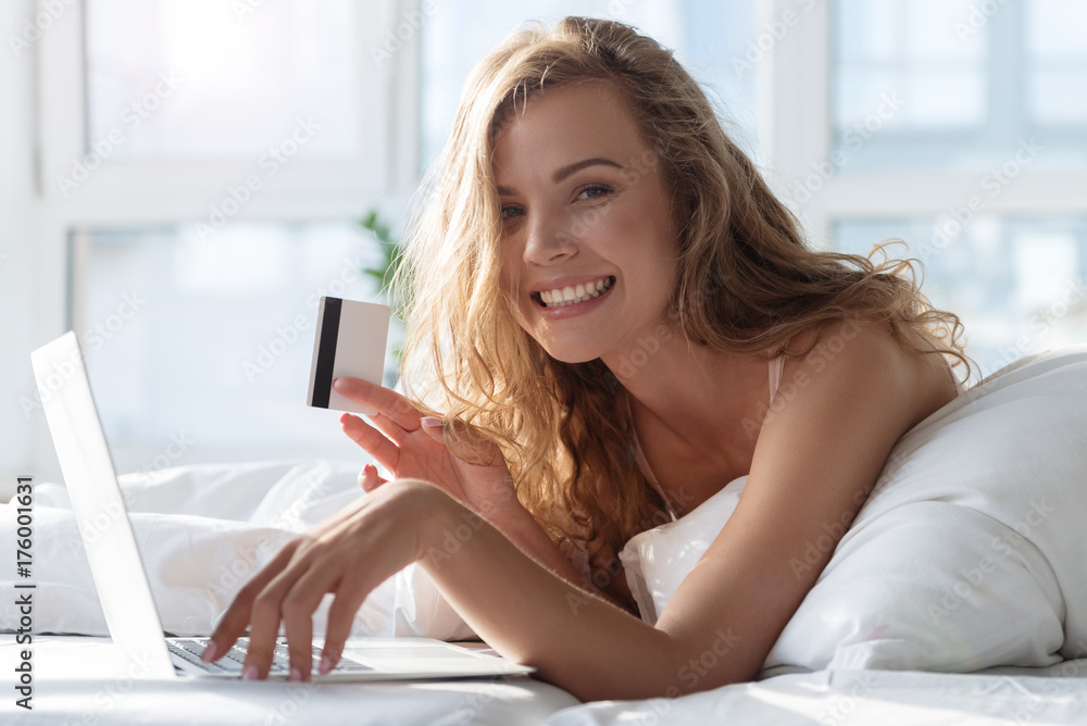 Hilarious smiling female person holding card Hilarious smiling female person holding card