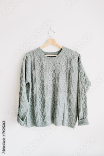 Women warm sweater on hanger. Fashion look.