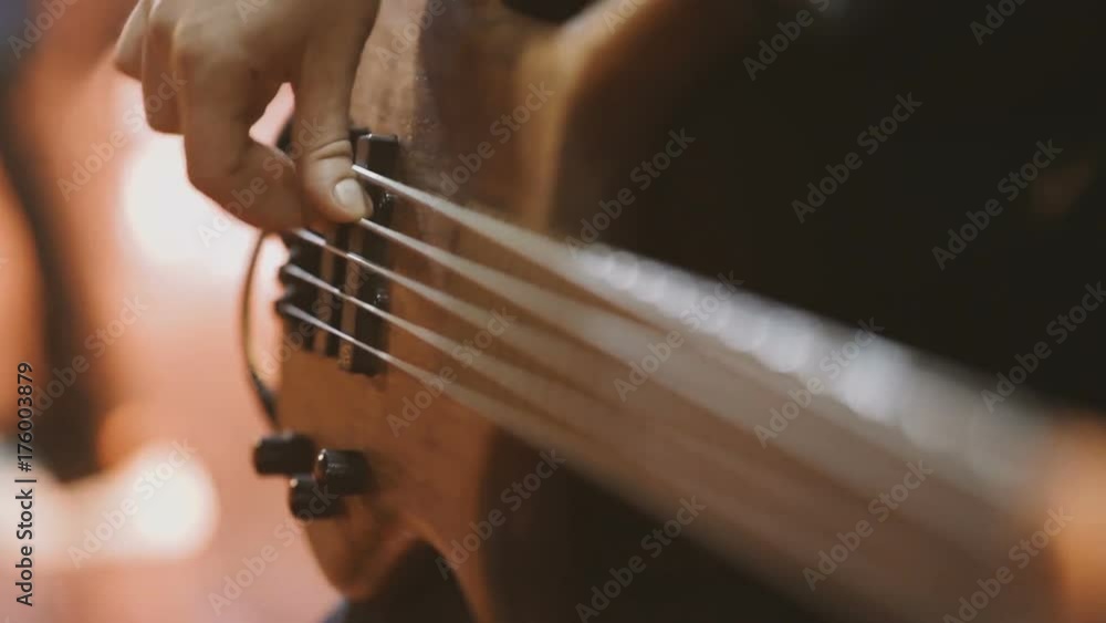 Man bass guitarist playing electrical guitar on concert stage Man bass guitarist playing electrical guitar on concert stage