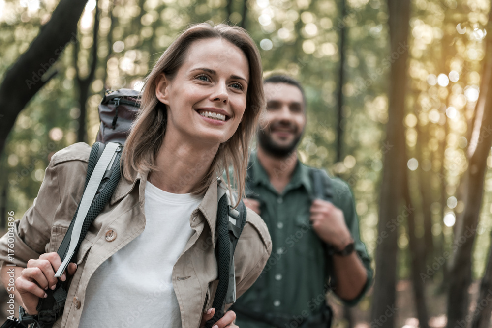 Happy loving couple admiring nature in the forest Happy loving couple admiring nature in the forest