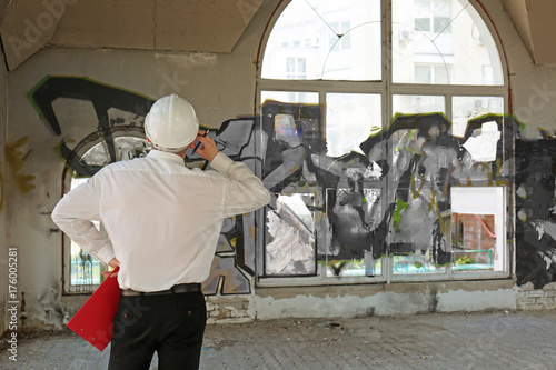 Insurance adjuster inspecting abandoned building photo