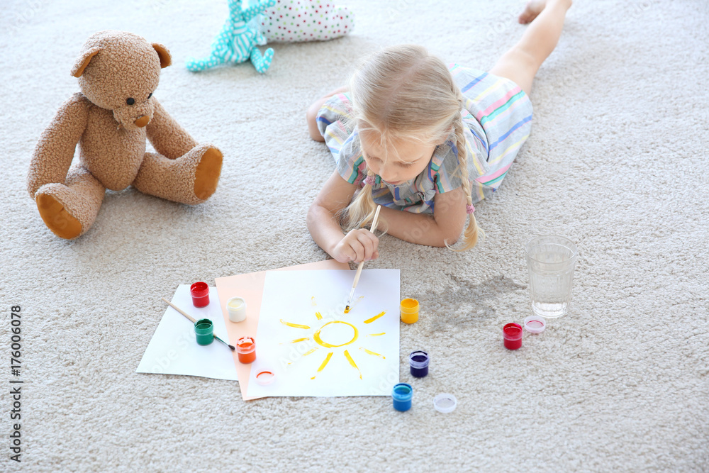 © Africa Studio - Cute little girl painting picture and spilled water on carpet