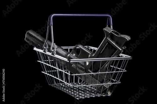 Pistol in a shopping cart. Isolated on black background. With copy space text. Studio Shot.