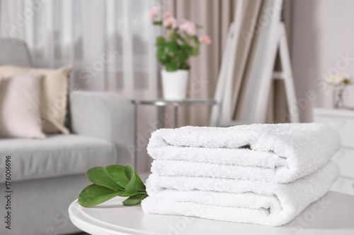Clean white towels on table at home