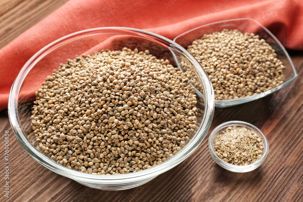 Bowls with hemp seeds on wooden table Bowls with hemp seeds on wooden table