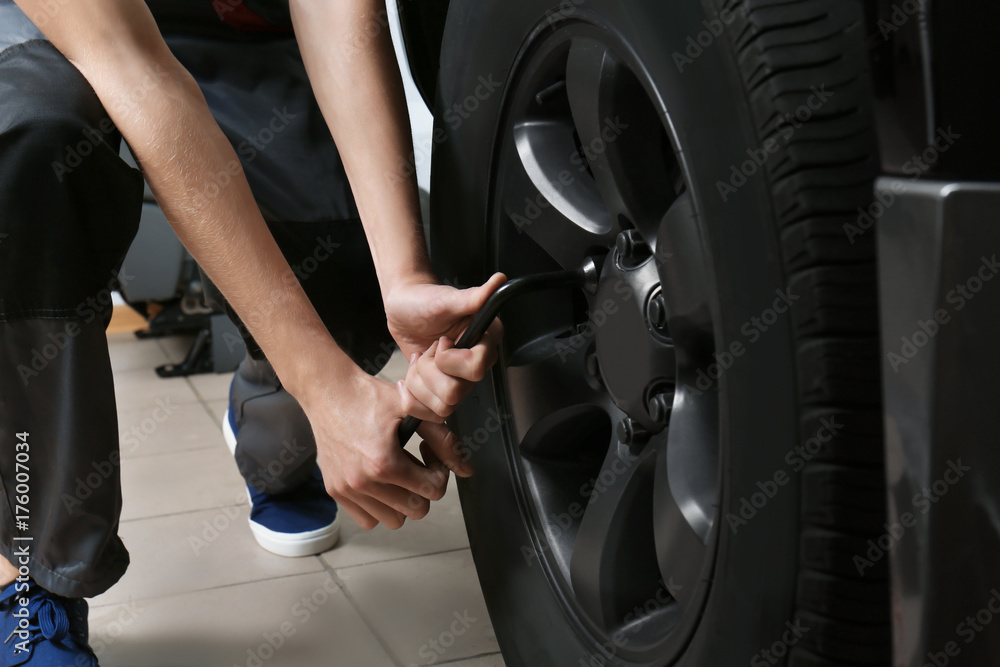 Young mechanic working in body shop Young mechanic working in body shop