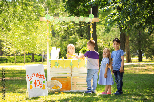 Adorable children standing in line for homemade lemonade outdoors