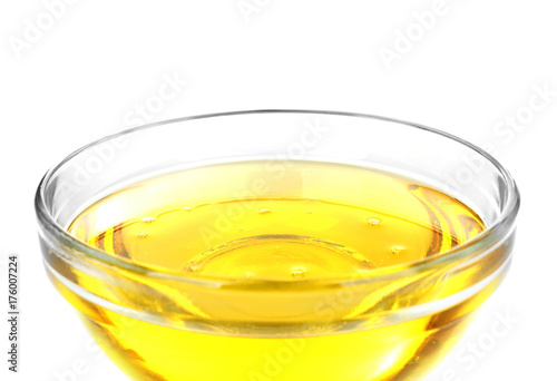 Glass bowl with cooking oil on white background