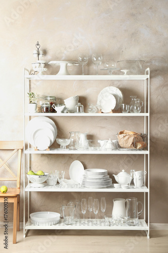 Storage stand with glass and ceramic tableware indoors