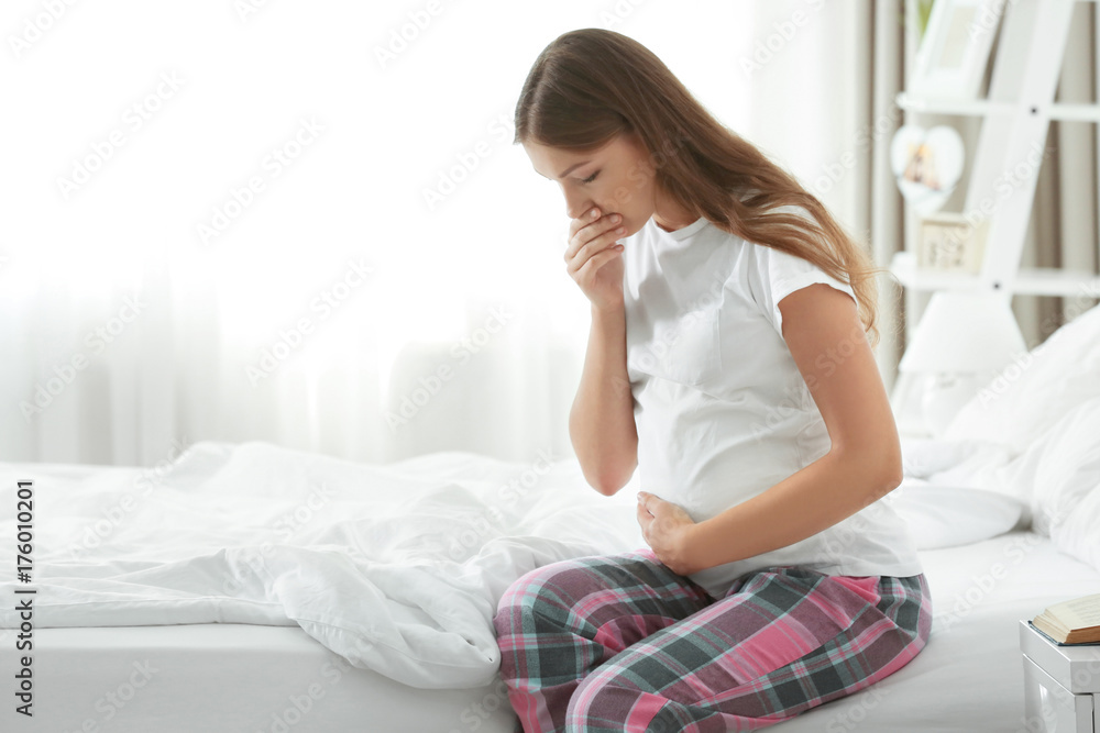 Young pregnant woman suffering from morning sickness - obrazy, fototapety, plakaty 