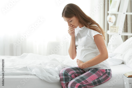 Fototapeta Young pregnant woman suffering from morning sickness
