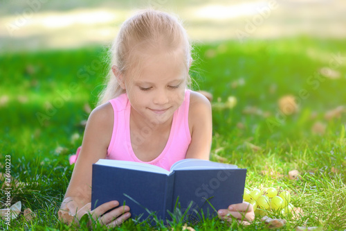 Cute little girl with book ...