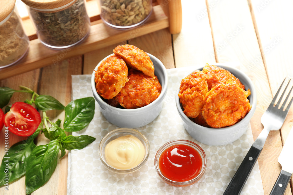 Bowls with tasty sausage balls and sauces on table Bowls with tasty sausage balls and sauces on table