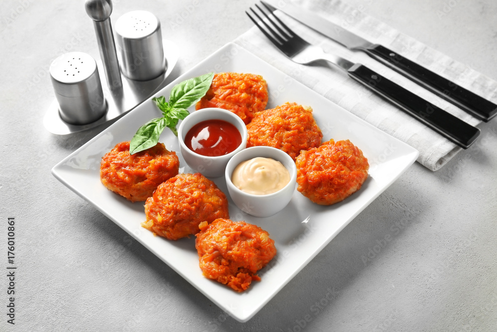 Plate with tasty sausage balls and sauces on table Plate with tasty sausage balls and sauces on table