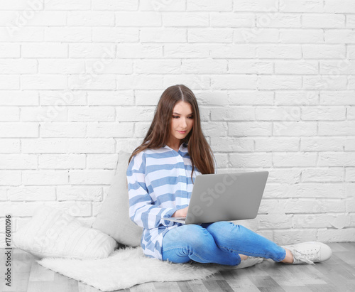 Young woman with laptop at home