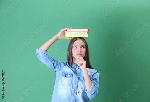 Teenager girl with books on...