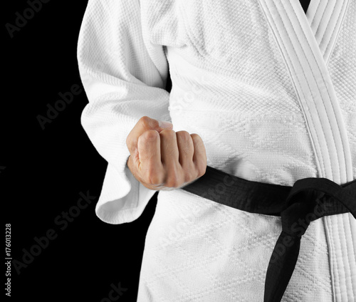 Male karate instructor on dark background, closeup