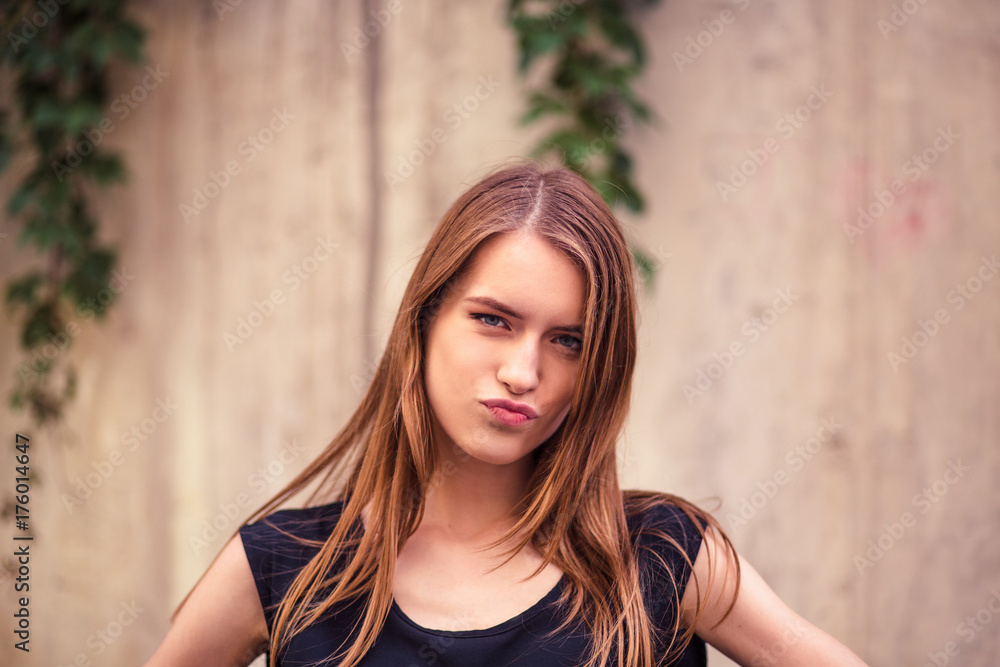 Attractive young woman with thoughtful face. Portrait of pretty young woman with long hair and beautiful face. Toned image. Attractive young woman with thoughtful face. Portrait of pretty young woman with long hair and beautiful face. Toned image.