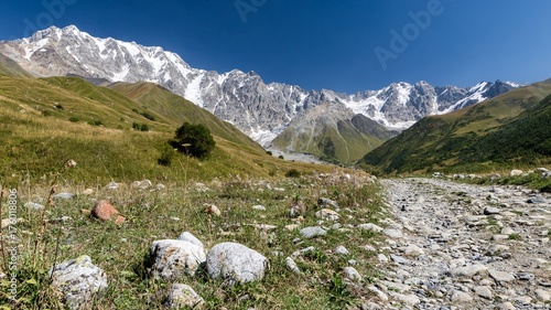 Panoramic view of the path to the Shkara glacier in Georgia photo