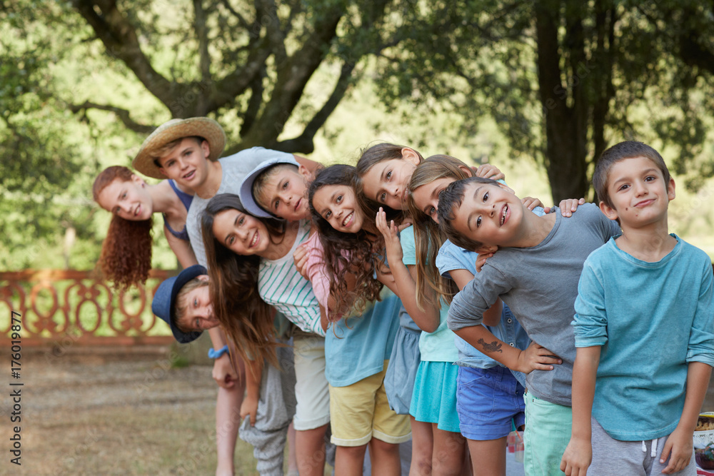 Group portrait of ten children at an outdoors party in a fun mood Group portrait of ten children at an outdoors party in a fun mood