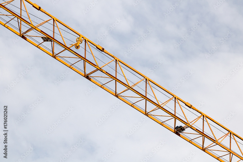 The crane arm on a cloudy sky background