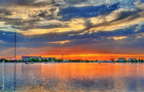 Sunset over the city lake in Navoi, Uzbekistan photo