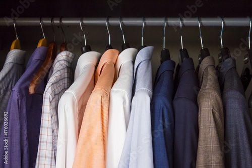 Row of colorful clean, pressed shirts in a closet