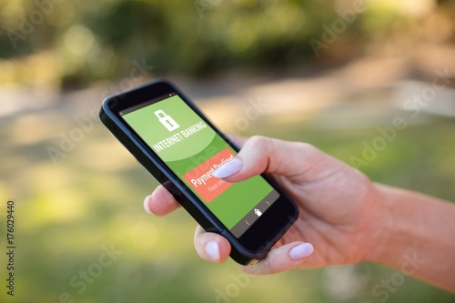 Composite image of internet banking text on green mobile display
