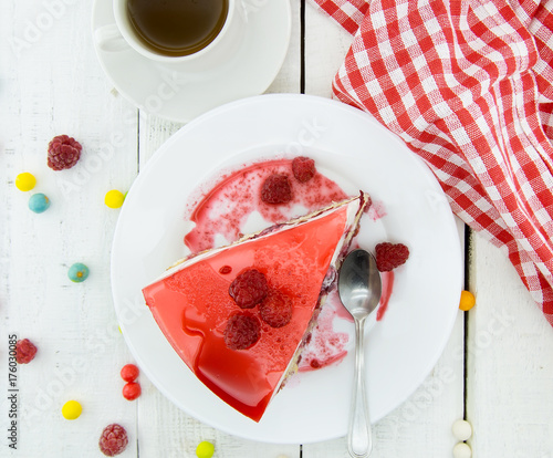 Slice of vanilla sponge cake with yogurt souffle and raspberry jelly. Sweet food for holiday. Top view