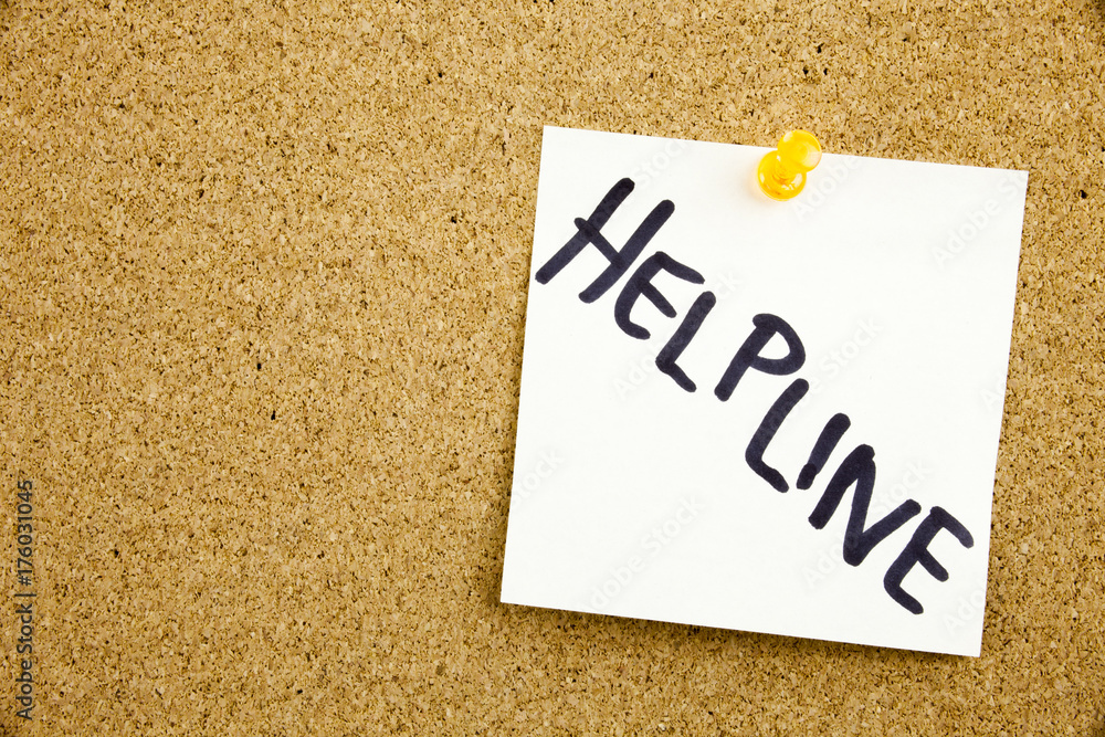A yellow sticky note writing, caption, inscription Phrase HELP LINE HELP LINE in black ext on a sticky note pinned to a cork notice board A yellow sticky note writing, caption, inscription Phrase HELP LINE HELP LINE in black ext on a sticky note pinned to a cork notice board