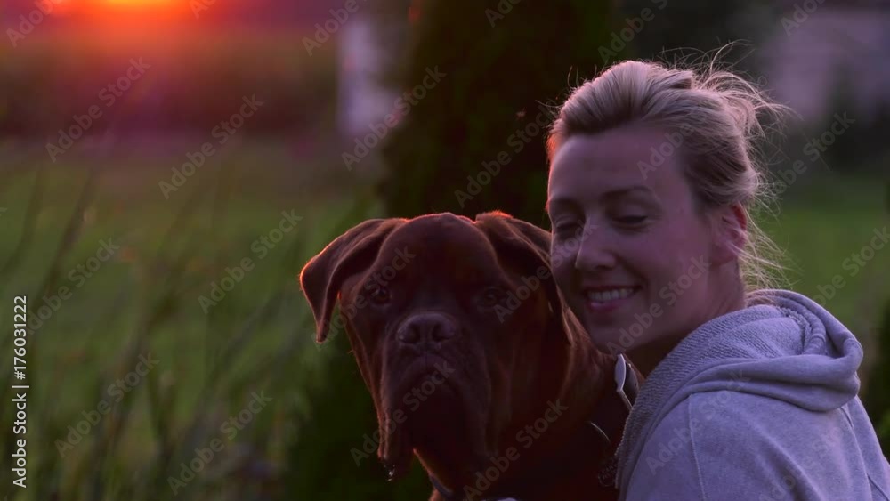girl and her dogue de bordeuax mastiff look at camera in sunset 4k girl and her dogue de bordeuax mastiff look at camera in sunset 4k