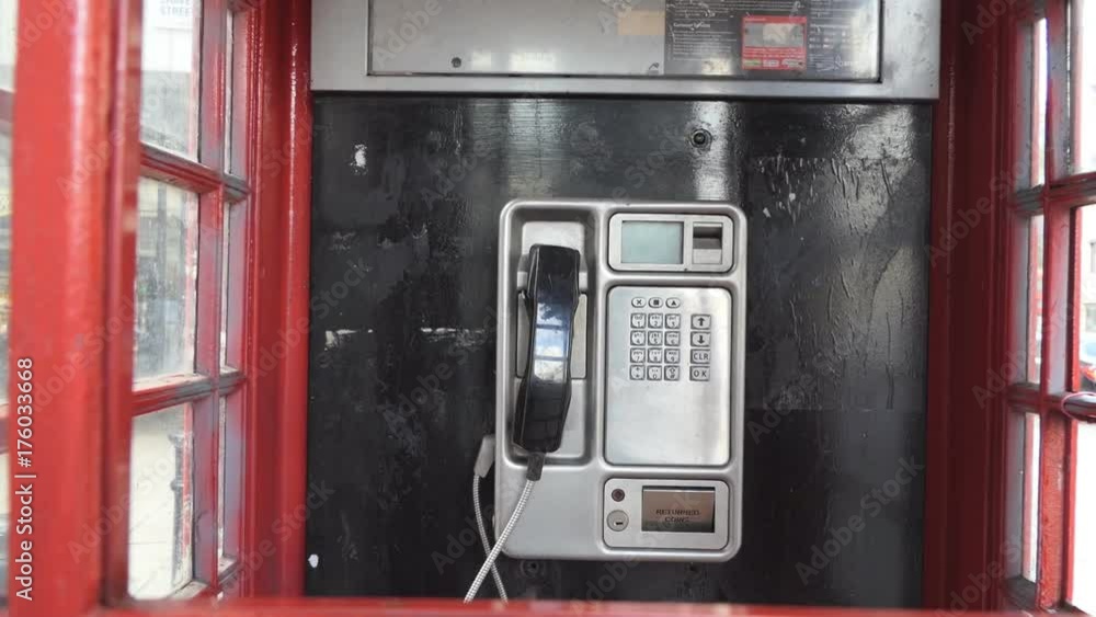 Phone in a red telephone booth. Phone in a red telephone booth.