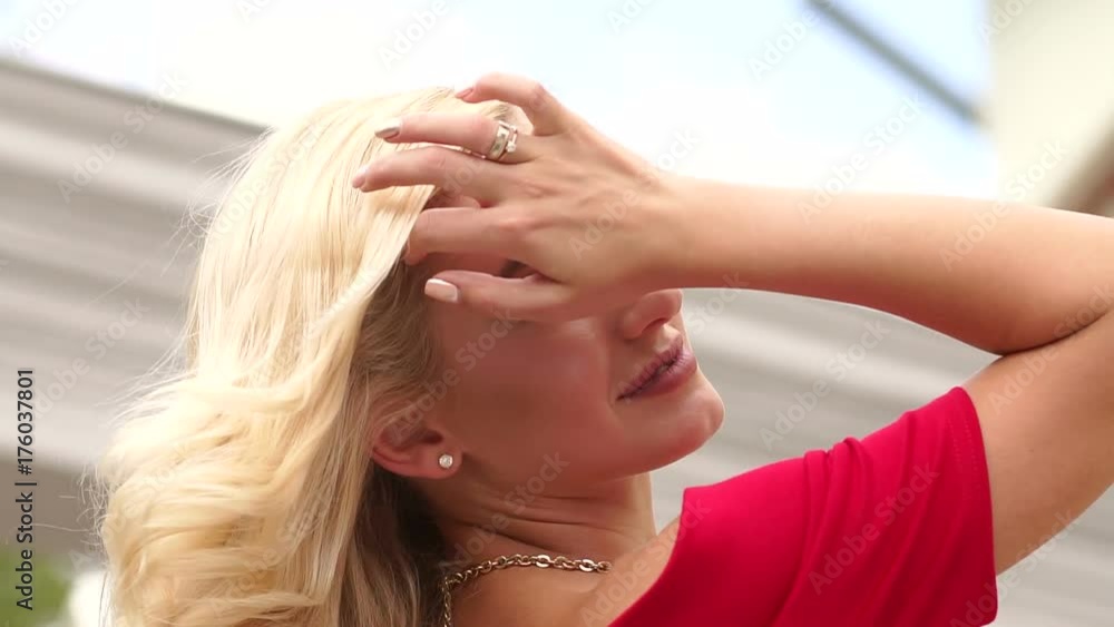 Close-up portrait of a young girl with long waving in the wind blond hair outdoors. Close-up portrait of a young girl with long waving in the wind blond hair outdoors.