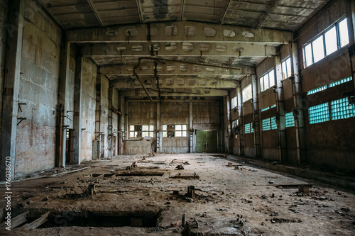 Abandoned industrial warehouse on ruined brick factory, creepy interior, perspective