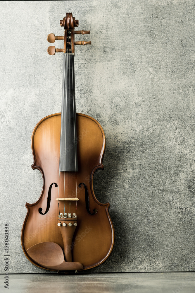 vintage violin on concrete background