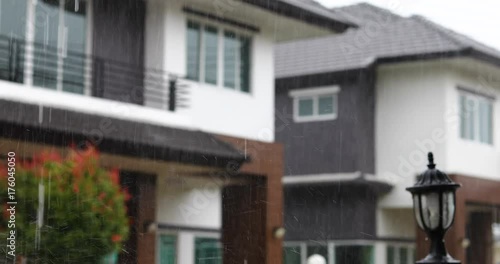 rainy day scene, focus rain falling in sky with blur house background