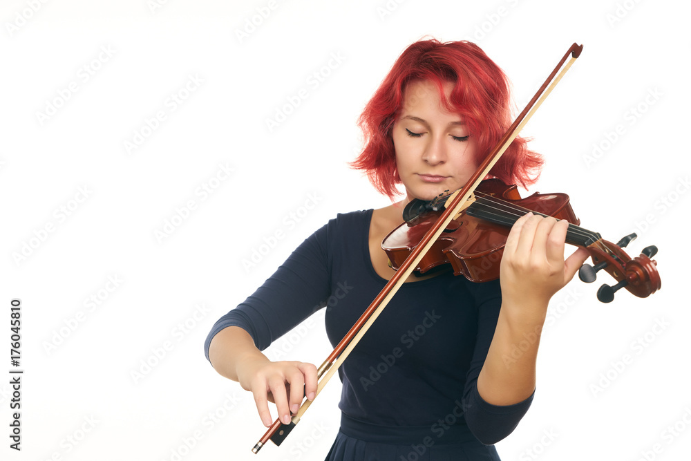 Beautiful young redhead woman playing the violin Beautiful young redhead woman playing the violin