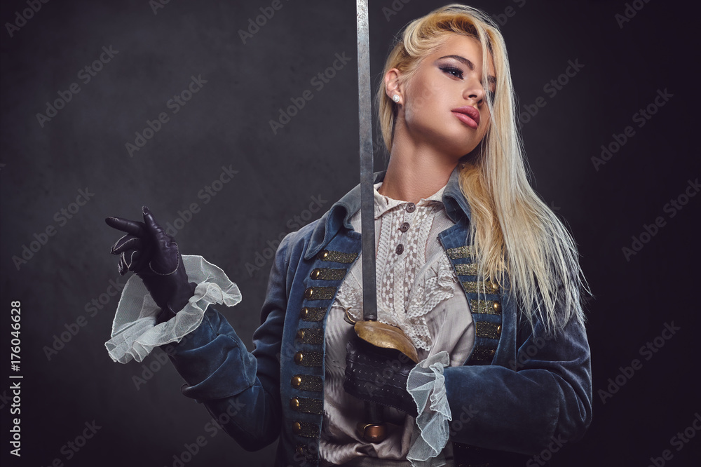 An attractive blonde female holds a silver sword.